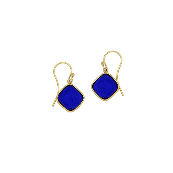 Gold earrings with blue square stones on a white background