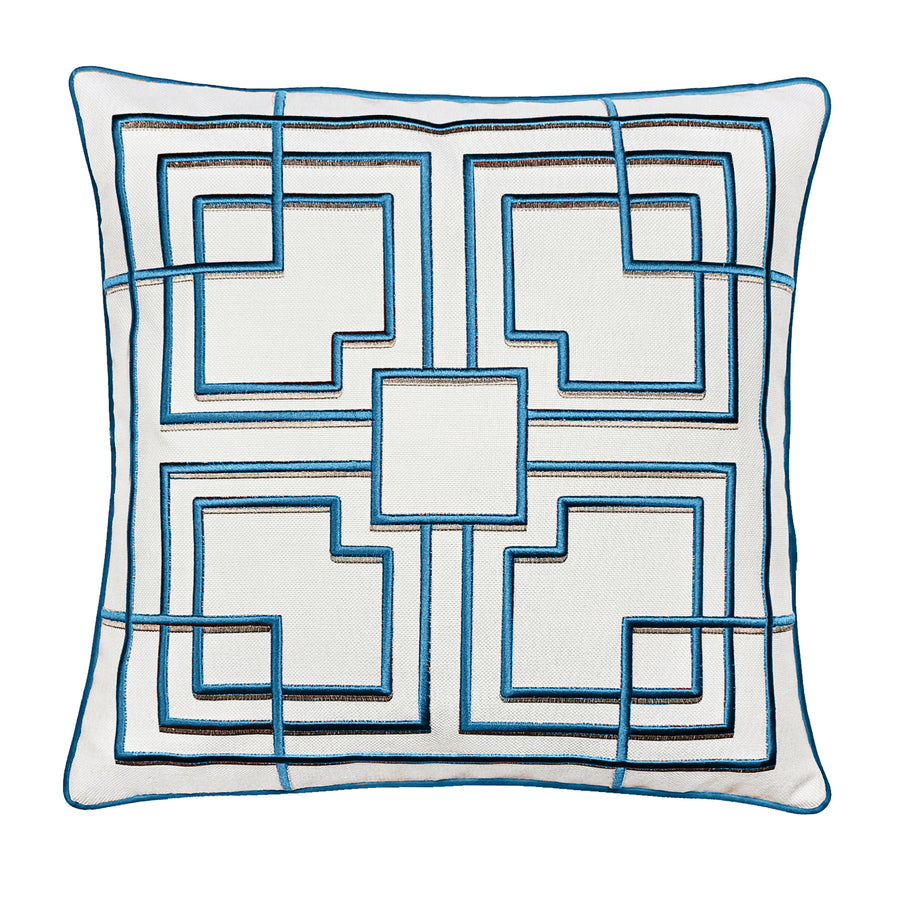A square-shaped pillow with a white background featuring a geometric pattern of teal blue embroidery in a diamond shape.