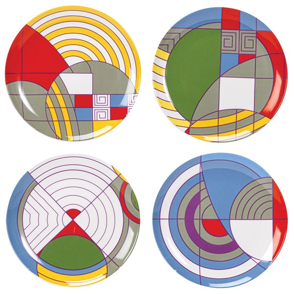 A set of four ceramic dessert plates, each with a geometric rug design in different colors.