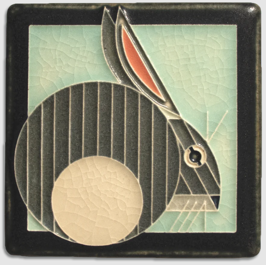 Decorative tile with a stylized rabbit design on a textured background