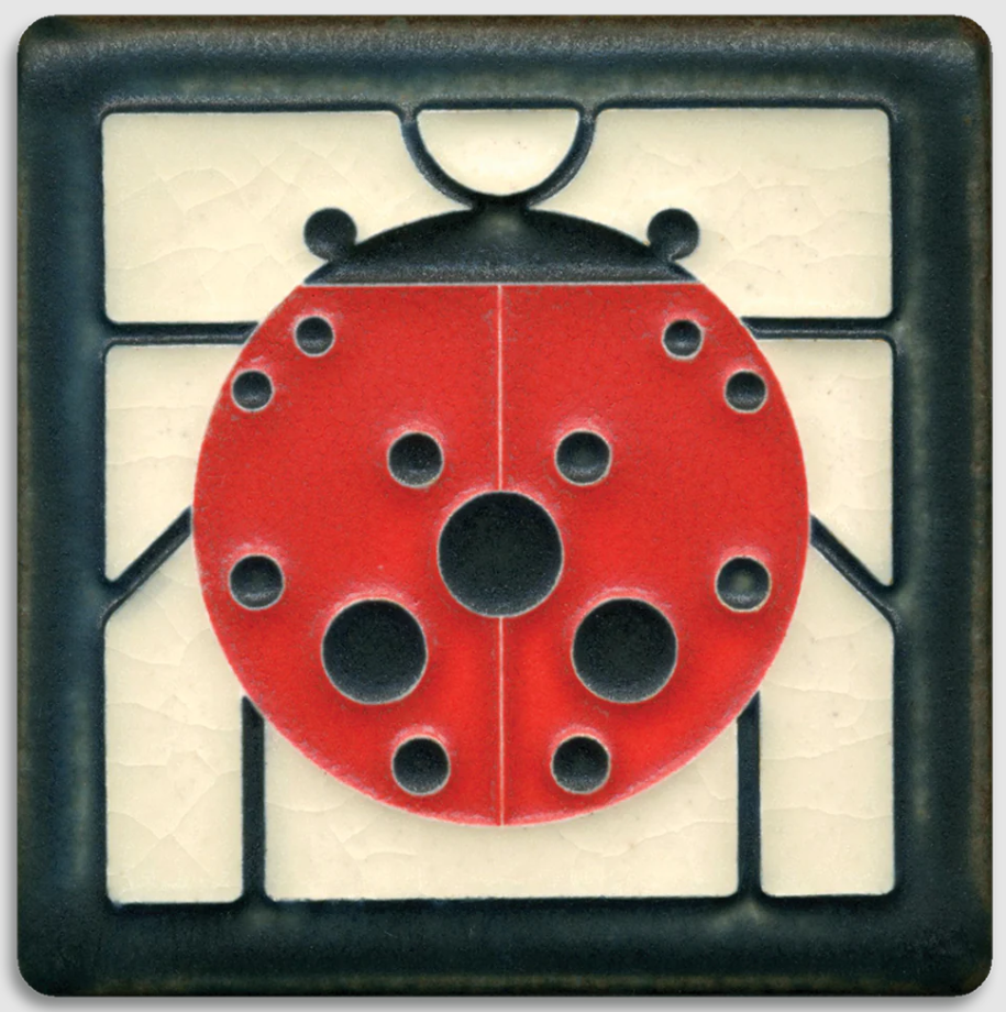 Decorative tile with a red ladybug design on a beige background