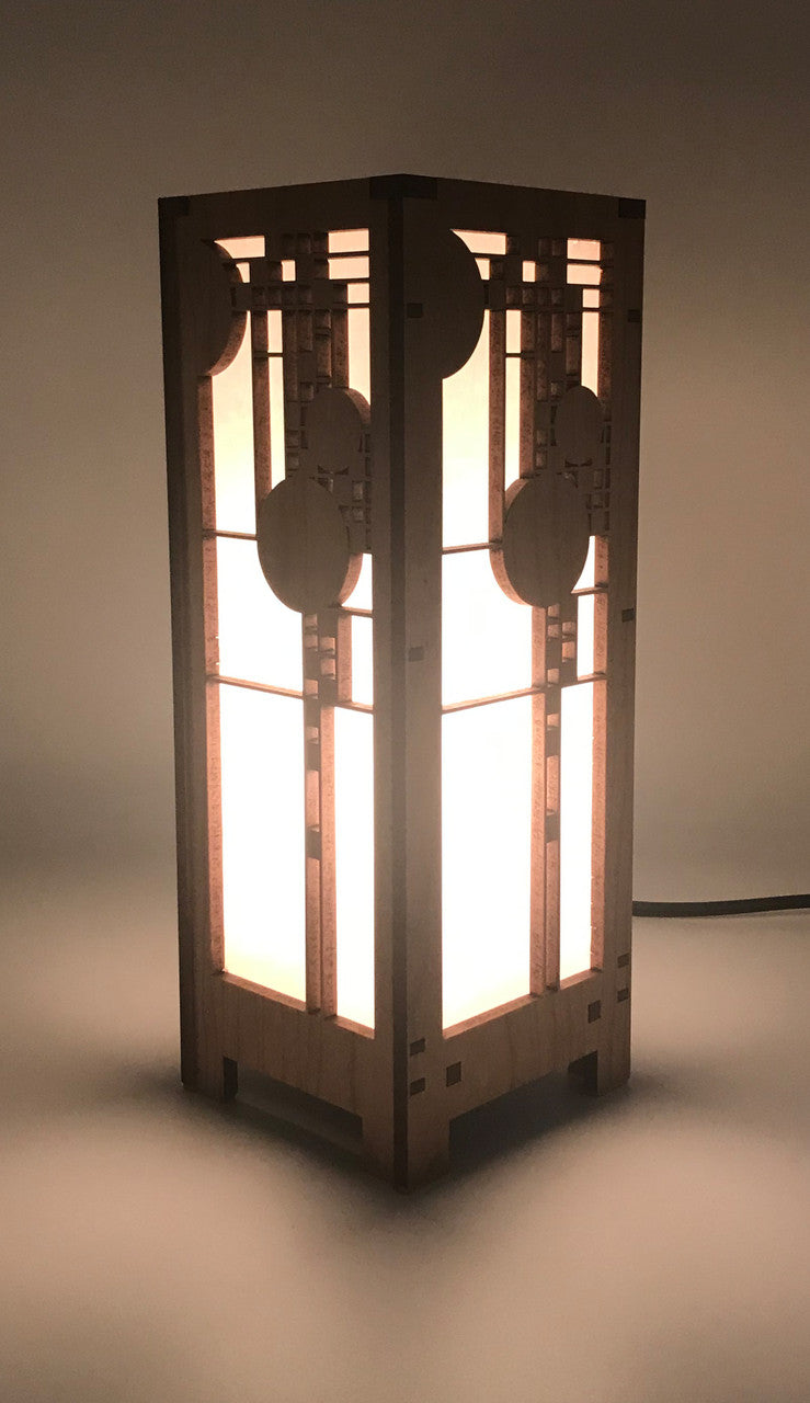 A mini lightbox lamp with geometric art glass window designs, made of cherry veneered MDF and shoji paper, with an illuminated candelabra base.