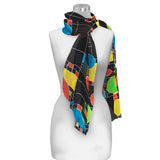 A multicolored geometric patterned scarf displayed on a mannequin.
