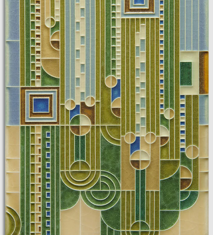 Decorative tile with geometric pattern in green, brown, and blue