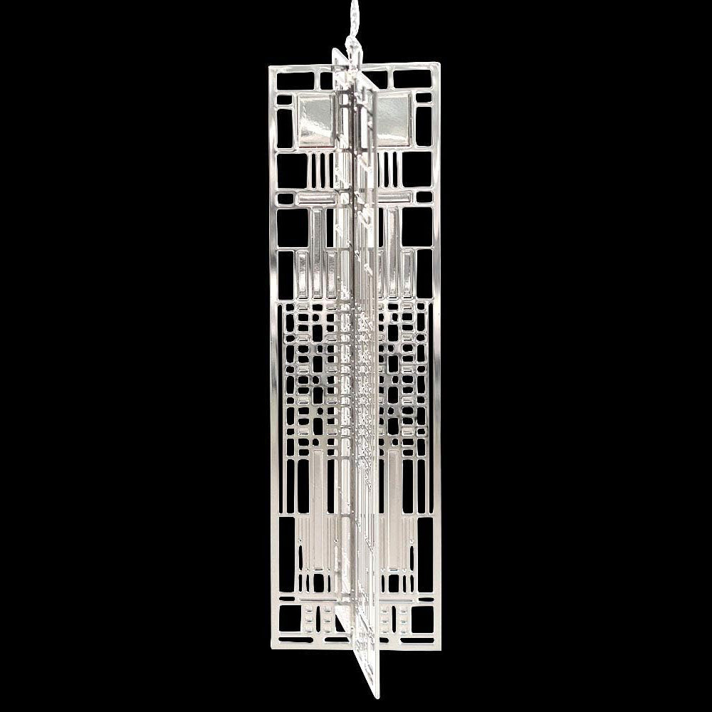 A silver-plated brass ornament with a geometric window design pattern.