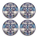 A set of four round stone coasters with a geometric waterlilies pattern and cork backing.