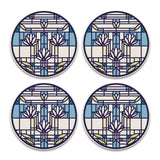 A set of four round stone coasters with a geometric waterlilies pattern and cork backing.