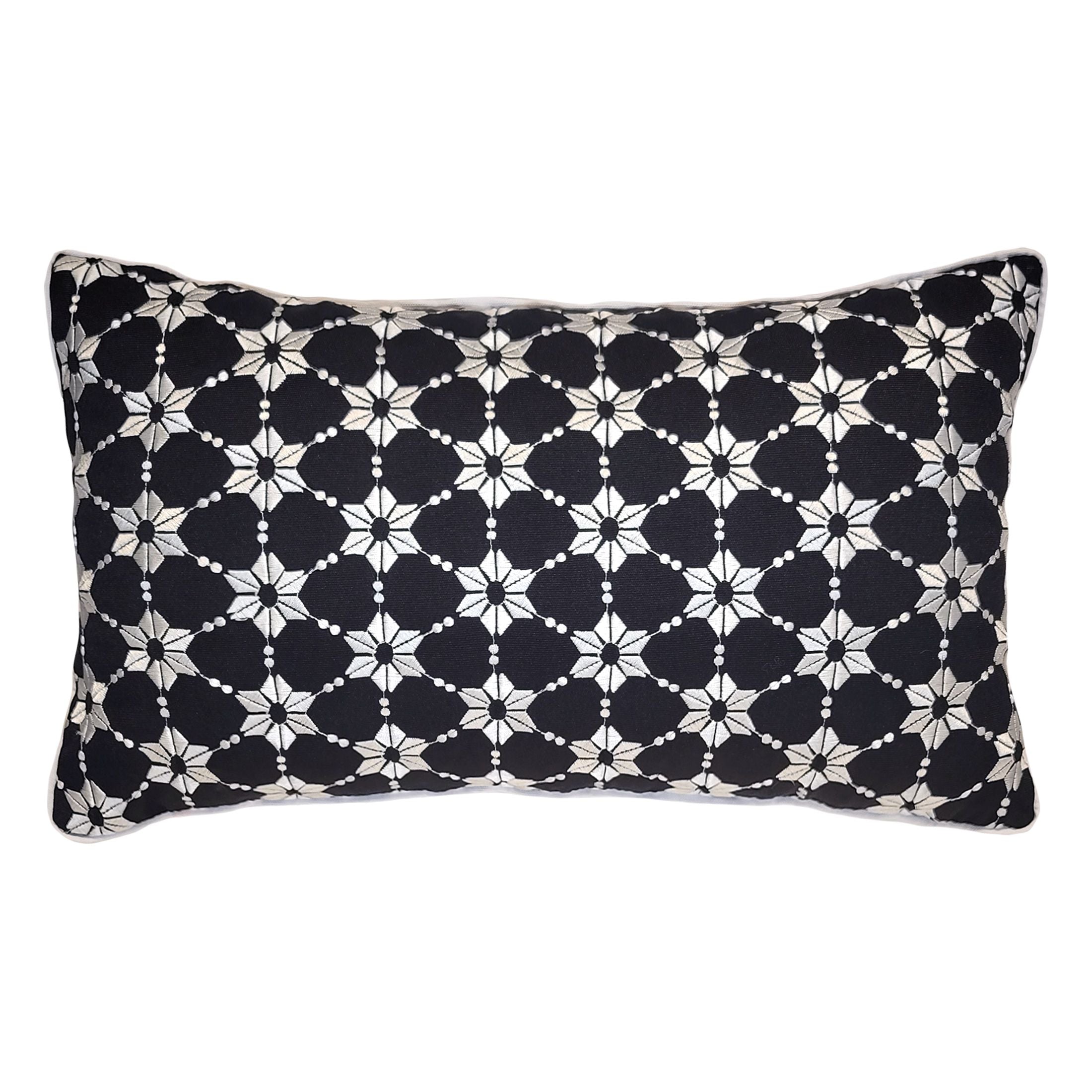 Decorative pillow with black and white geometric pattern on a white background