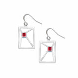 Silver earrings with red gemstones on a white background