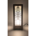 A rectangular lightbox lamp with a design that resembles a window from the Robie House, illuminated by a bulb.