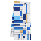 A folded 100% cotton tea towel with a geometric pattern in blue, white, and other colors, inspired by Frank Lloyd Wright's work.