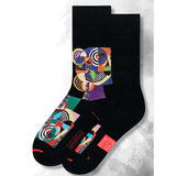Black socks with colorful abstract pattern on a light gray background