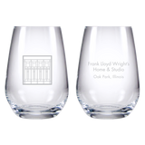 Two clear glasses with engraved text on a white background