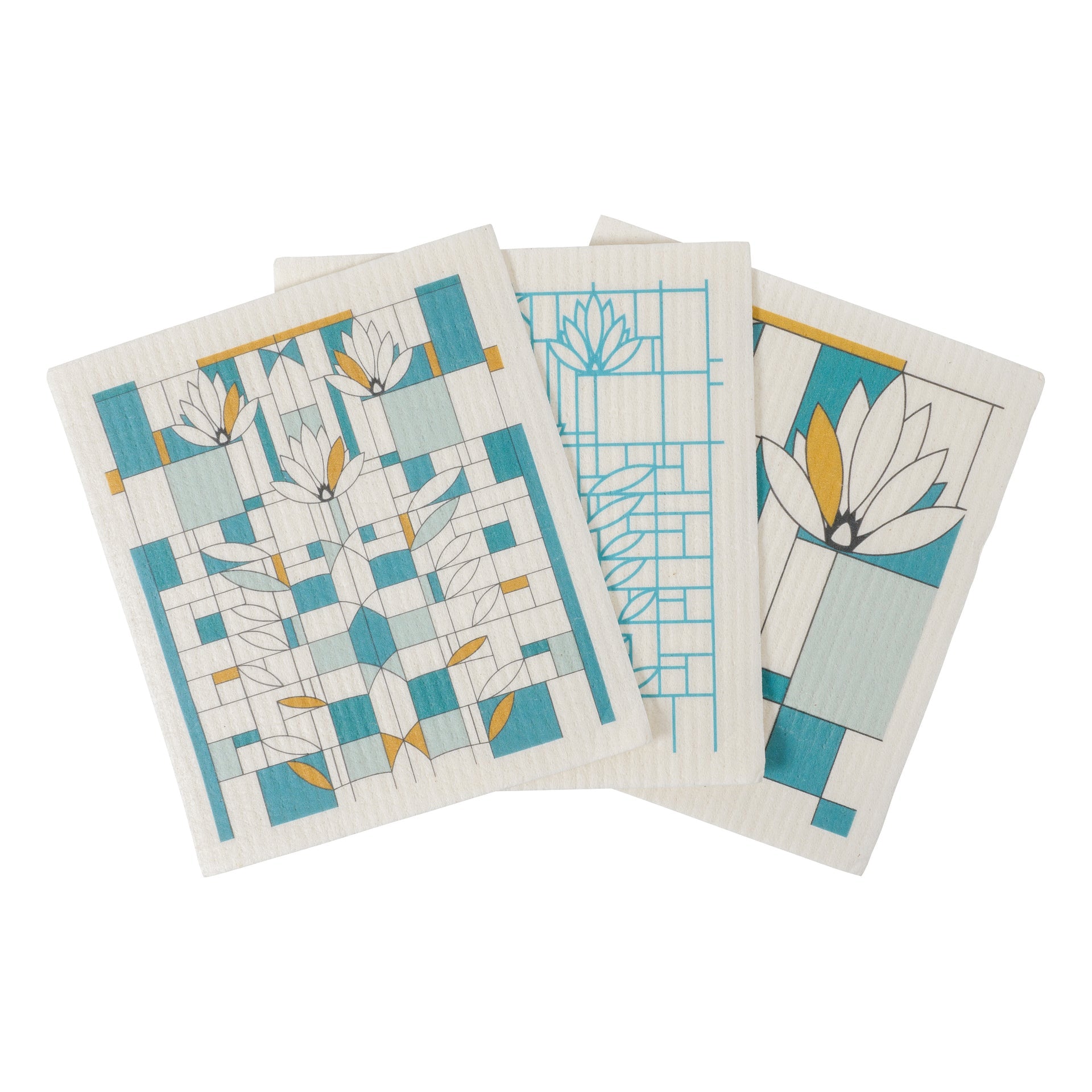 Three white dish cloths with blue and yellow waterlily designs and geometric patterns.