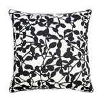 Decorative pillow with black leaf pattern on a white background