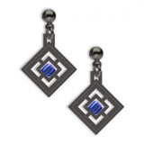 A pair of drop earrings with a geometric window design featuring a central blue square bead, made of solid brass with a hematite finish, and glass beads.
