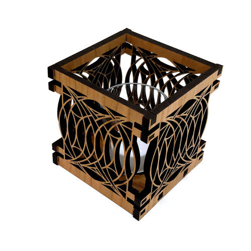 A square wooden votive holder with geometric cut-outs and a glass votive candle holder inside.
